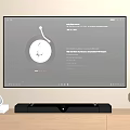 Wall Mounted TV Displaying Vinyl Record Interface With Soundbar White Speaker And Table Lamp