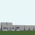 Industrial Factory Building With Gray Exterior Multiple Windows Doorways Green Grass Field And Tall Tower