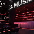 Bar with VA Music Neon Sign Shelves Filled with Bottles Dark Interior and Red Lighting