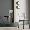 Two Modern Dining Chairs Featuring Wooden And Fabric Seats In Gray Wall With Round Lights