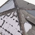 Snow Covered Corrugated Metal Roof With Multi Sloped Structure And Intersecting Ridges