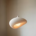 Modern White Textured Pendant Light with Unique Curved Shape and Warm Glow in Minimalist Interior