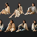 Group of Women in Casual Outfits With Different Sitting Poses on Dark Background