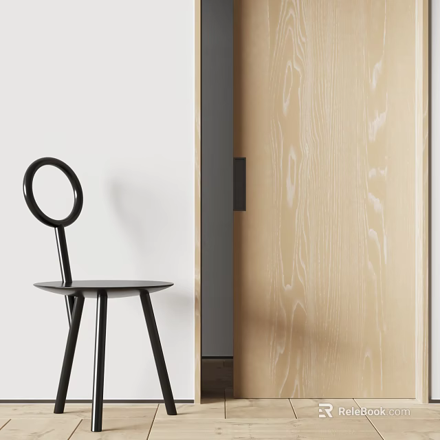 Black Dining Chair With Round Backrest Three Legs Near Light Wood Grain Door And White Wall 3d model 
