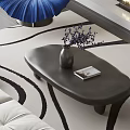 Oval Dark Modern Coffee Table With Purple Flowers Vase And Book On White Sofa Rug