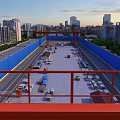 Road Infrastructure Construction at Urban Site With Red Crane Structure and Blue Barriers