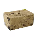 Brown Cardboard Box With Black Stains And White Labels On Soiled Surface