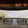 Traditional Cultural Exhibition Hall Featuring Circular Ceiling Pattern And Illuminated Display Stands