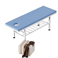 Blue Padded Treatment Table With Central Hole And Metal Frame Near Sofa