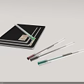 Stacked Black Notebooks With Assorted Colored Pens Lying On Gray Surface 3d model