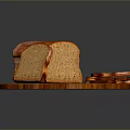 Fresh Brown Bread On Wooden Round Cutting Board With Whole Loaf And Sliced Pieces