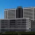 Modern Hospital Building With Tall Glass Facade Multiple Floors Green Surroundings And Water Reflection