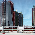 Modern Commercial Street With Red Glass High Rise Buildings And Parking Area