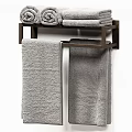 Soft Gray Bath Towels Folded And Hanging On Modern Wooden Rack