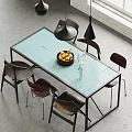 Modern Dining Table Set With Light Blue Tabletop Dark Chairs And Fruit Basket