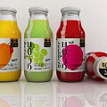 Colorful Fruit Juice Drinks in Glass Bottles with White Labels and Fruit
