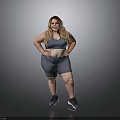 Woman in Gray Sports Bra and Gray Shorts with Hands on Hips Wearing Black Sneakers