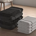 Soft Black And White Stacked Cotton Towels On Wooden Table For Home Bathroom Use