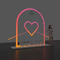 Woman Posing Next to Romantic Arch Landmark With Heart Neon Light