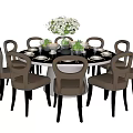 Modern Round Dining Table And Chairs Set With Beige Seats Black Legs White Flower Vase