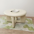 Round Cream Colored Coffee Table With Stack Of Magazines On Green White Patterned Rug 3d model
