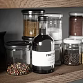 Kitchen Utensils Organized on Wooden Shelves with Black Jug Glass Jars Spices Mortar and Bowls
