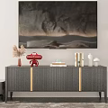 Dark TV Stand with Gold Accents against Stone Wall with Wall Art and Decorative Items