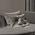White Throw Pillows With Flower Shaped Design And Yellow Center On Gray Sofa