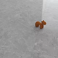 Gray Marble Texture Floor Tiles With Small Brown Wooden Animal Toy On Surface