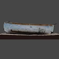 Vintage Weathered Blue Wooden Boat With Worn Paint On Gravel Platform