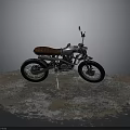Vintage Motorcycle with Silver Body and Brown Leather Seat Parked on Weathered Ground