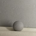 Gray Textured Sphere Component On Neutral Surface With Gray Wall Background