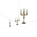 Set of Three Ornate Metal Candleholders With Various Heights And Decorative Details