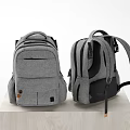 Two Gray And Black Backpacks With Multiple Pockets Adjustable Straps On Wooden Platform 3d model