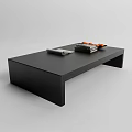 Modern Black Coffee Table With Sleek Design Stacked Books And Orange Decorative Items