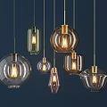 Modern Glass Pendant Lights In Various Shapes With Golden Metal Frames And Illuminated Bulbs