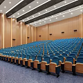 Spacious Conference Room Auditorium Style With Blue Seats Wooden Walls And Ceiling Lights