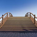 Wooden Bridge With Curved Railings Stairs And Blue Sky Green Grass