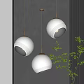 Modern Textured White Spherical Pendant Lights With Golden Chains And Green Plants On Dark Wall