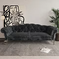 Dark Tufted Velvet Two Seater Sofa With Floor Lamp Green Plant And Abstract Painting