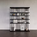 Modern Black Bookshelf with Books Decorative Bowls Vases Against Gray Wall Dark Wooden Floor