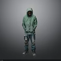 Man in Green Hoodie and Ripped Jeans Standing Against Gray Background with Sneakers