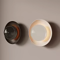 Modern Black and White Wall Sconces Minimalist Design Mounted on Beige Wall With Warm Lighting