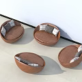 Round Single Seater Sofa With Wooden Frame And Plaid Cushions Against White Wall