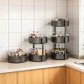 Three Tier Black Rotating Storage Racks On Kitchen Countertop For Organizing Spice Jars And Bottles