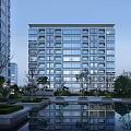 Modern High Rise Residential Building With Glass Facade Surrounding Greenery And Reflection Pool