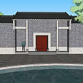 Traditional Ancient Chinese Architecture with Gray Walls Black Tiled Roof Red Door Pond and Trees