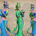Three Colorful Traditional Female Statues As Garden Ornaments With Vibrant Hues And Intricate Details