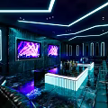 Modern KTV Lounge With Neon Lighting Large Screens Bar Counter And Seating
