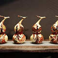 Decorative Gourd Shaped Ornament Set Featuring Colorful Patterns On Wooden Surface